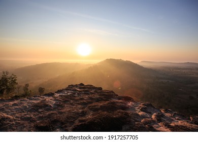 The morning light on the top of a hill filled with rocks and trees. - Powered by Shutterstock