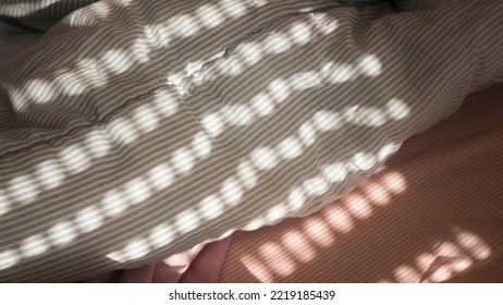 Morning Light Through Blinds In Bed