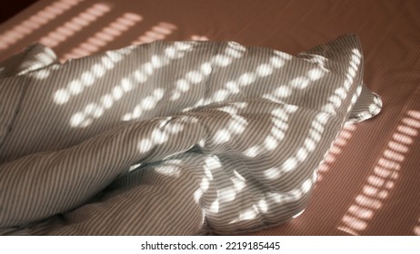 Morning Light Through Blinds In Bed