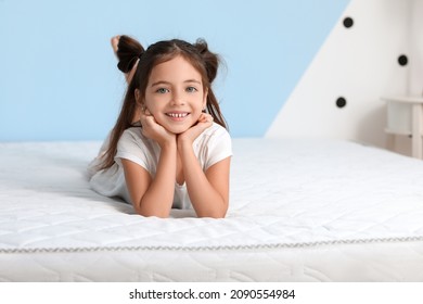 Morning of little girl lying on bed with comfortable mattress - Powered by Shutterstock