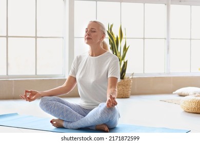 Morning Of Mature Woman Meditating At Home