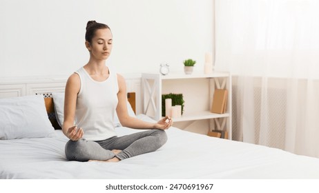 Morning Meditation. Woman Practising Yoga In The Morning, Sitting On Bed, Free Space - Powered by Shutterstock