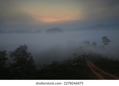 Morning mist at Khao Kuan Ta Noi (Doi Chet Chan) viewpoint.
A panorama view to the north follows the ridge line of the Khao Thalu mountain.
Khao Khai ,Sawi district, Chumphon province,Thailand  - Shutterstock ID 2278246875