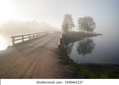 Morning misty landscape with old wooden bridge and trees suluets, Valaam Island, Karelia, Russia. - Shutterstock ID 1430461127