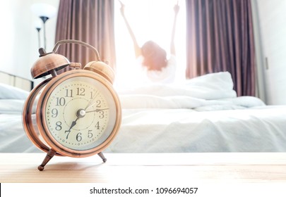 Morning of a new day, alarm clock wake up woman sitting in the room. A woman stretch the muscles at window. Health and care concepts - Shutterstock ID 1096694057