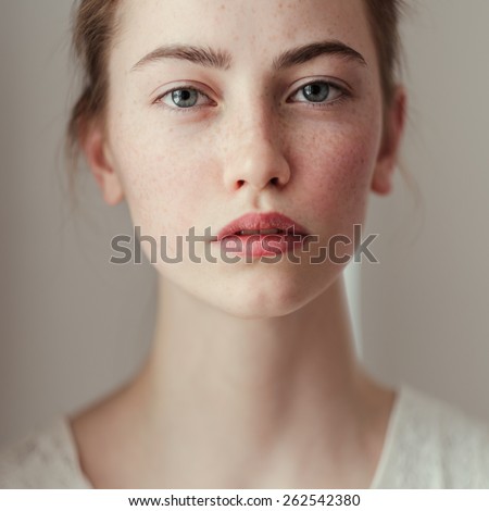 Morning portrait of a beautiful young girl with freckles