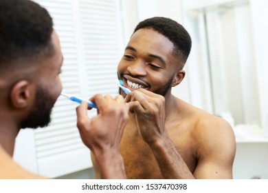 Morning Procedures. Millennial Black Guy Brushing His Teeth In Bathroom