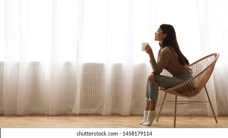Morning Relaxation. Girl Sitting in Armchair And Enjoying Coffee against Window, Free Space - Shutterstock ID 1458179114