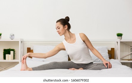 Morning Routine Concept. Girl Stretching Her Legs And Doing Yoga In Her Bed, Panorama