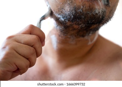 Morning routine. Young man shaving his face - Shutterstock ID 1666399732