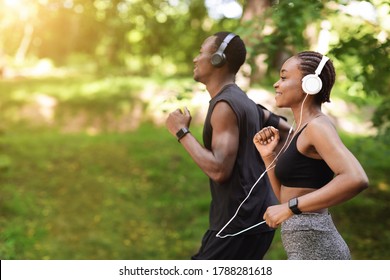 Morning Run Concept. Sporty Black Man And Woman Jogging Outdoor In City Park, Side View Shot With Copy Space - Shutterstock ID 1788281618