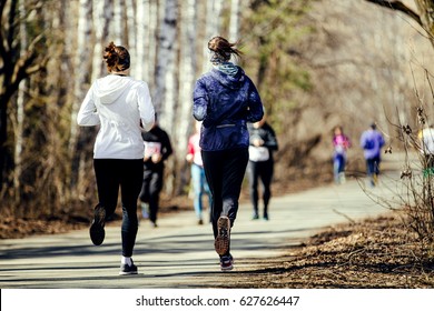 Morning Run Group Women Running In Sunny City Park