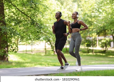 Morning Run. Sporty Black Guy And Girl Jogging Together In Green Park, Full-Length Shot With Free Space
