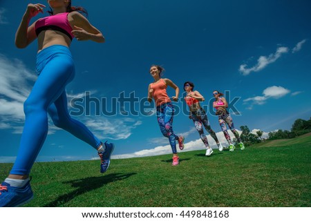 Morning running. Running athletes. Group of female runners on scamper.