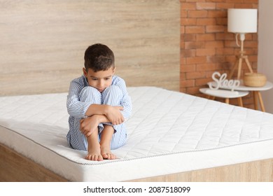 Morning Of Sad Little Boy Sitting On Bed