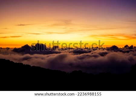 Morning sea fog at sunrise in the mountain, and the white fog and the orange sky
