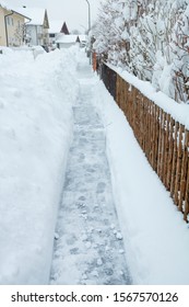 In The Morning Seven O Clock - Snow Removed From The Sidewalk After A Heavy Snowfall In The Night Before. Civic Duty In The Cities