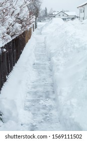 In The Morning Seven O Clock - Snow Removed From The Sidewalk After A Heavy Snowfall In The Night Before. Civic Duty In The Cities