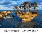 Morning sun lights up a rock formation on Lake Huron. Locally known as Turnip Rock, it is a popular destination for kayakers during the summer season. As winter heralds a new beginning, pancake ice be