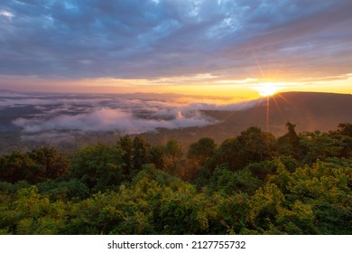 Morning sun rays through clouds and fog over mountains at Arkansas Grand Canyon Scenic Overlook - Powered by Shutterstock