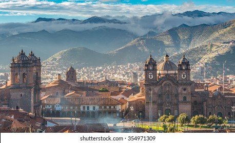 Morning sun rising at Plaza de armas with Adean Moutain and group of cloud, Cusco, Peru