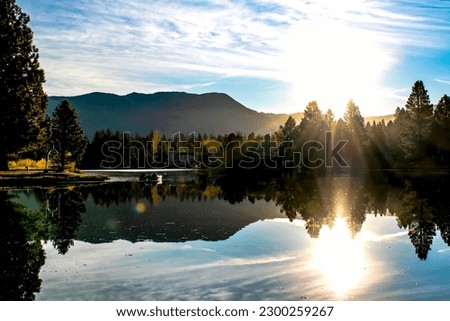 Morning Sunrise Along Tahoe Keys Lake With Reflecting Mountain Range in South Lake Tahoe, CA