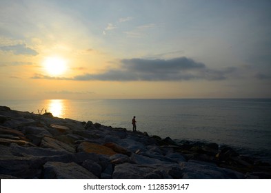 Morning Sunrise At The Beach With Human Silhoutte