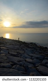 Morning Sunrise At The Beach With Human Silhoutte