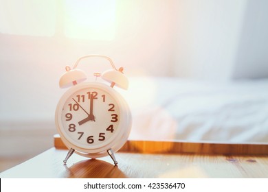 Morning Time Background, Alarm Clock Near The Bed At Home