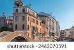 Morning in Venice timelapse. Canal with bridge, historical old houses and boats. Scenic cityscape view. Venice, Italy. Blue sky at summer day