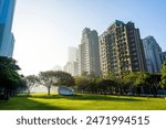 Morning view of green park space and modern buildings on both sides in downtown Taichung, Taiwan. here is near the National Taichung Theater.