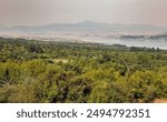 Morning view over Polyfytos artificial lake, Servia Neraida bridge and Velventos village. Larissa, Greece.