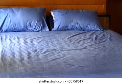 Morning View Of An Unmade Bed With Crumpled Blue Bed Linens And No People