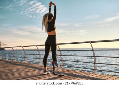 Morning warm-up at sunrise. Sports woman with a prosthetic leg is training. - Powered by Shutterstock