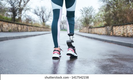 Morning workout. Cropped photo of of disabled athlete woman in sportwear with prosthetic leg standing outdoor - Powered by Shutterstock