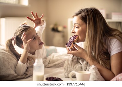 Morning with you are so funny. Mother and daughter  having breakfast in bed.  - Powered by Shutterstock