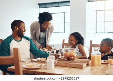 Mornings can be enjoyable when having breakfast with your family. a family having breakfast together at home. - Powered by Shutterstock