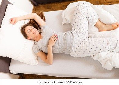 Mornings People Concept. Sleepy Woman Sleeping In The Bed. Attractive Lady Changing Sleep Positions.