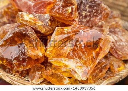 Moroccan Amber Resin Perfume sold on ethnically diverse spices and goods market. Gorgeous shards of smelly substance looks like perfectly clean isinglass-stone