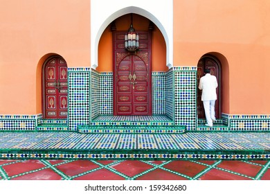 Moroccan architecture exterior detail of painted doors and mosaic tile work. Design symmetry. Location: Marrakech