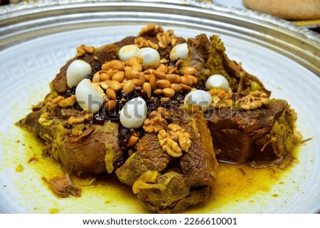 Moroccan dish with meat, plums ans sesameseeds close up