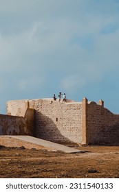Moroccan kids playing over ancient fortifications in the city of Rabat - Shutterstock ID 2311540133