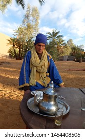 Moroccan Man Sit With Berber Tea In National Clothes In The Desert Of Merzouga, Sahara. Morocco, March 2018