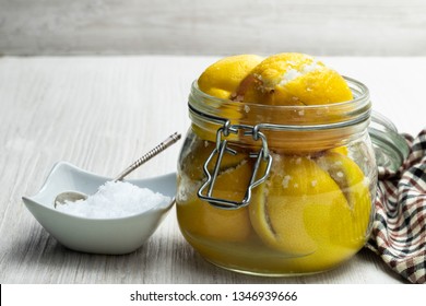 Moroccan  Preserved Salted Lemons In Glass Jar On White Wooden Table 