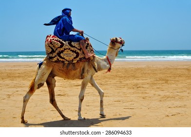 Morocco Berber Riding Camel On The Atlantic Ocean Beach