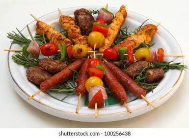 Morocco Marrakesh Traditional Grilled Chicken, Lamb, Sausage And Mixed Baby Vegetable Kebabs On A Skewer On A Bed Of Rosemary On A Typical Moroccan Plate