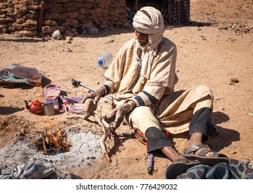 Morocco, Merzouga. 11 March 2014. Berber Man Prepares Tea In Sahara Desert