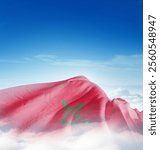 Morocco national flag waving in the clouds. The flag hiding in blue sky. Morocco national flag for independence day.