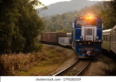 Morretes,PR/Brasil – Jul/2019: cargo train going down the mountain to deliver grains at the seaport.