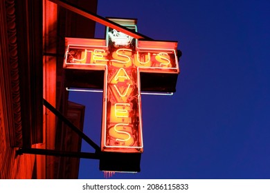 Morristown, NJ USA - December 17, 2020: Aglow in the nighttime winter sky, the Market Street Mission's iconic neon sign has become a local landmark off the historic town green in Morristown, NJ.